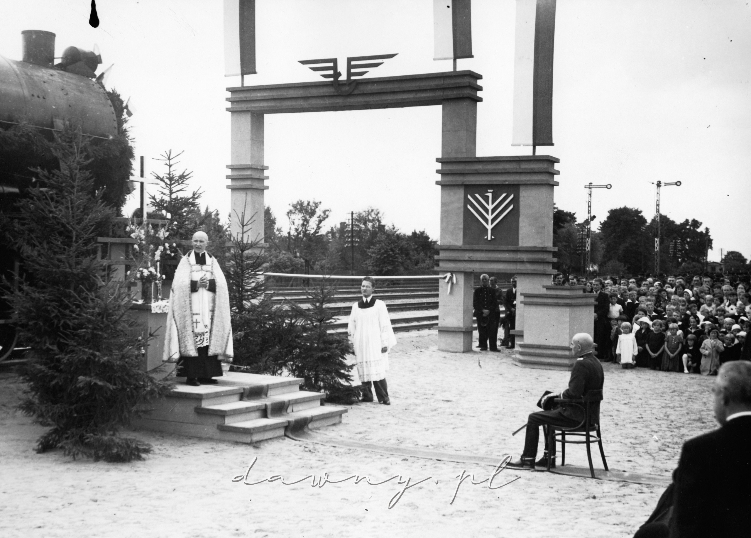 Ks. Andruszkiewicz podczas przemówienia na stacji Tłuszcz przed poświęceniem nowej linii. Gen. Edward Rydz-Śmigły siedzi na krześle). 22 sierpnia 1936